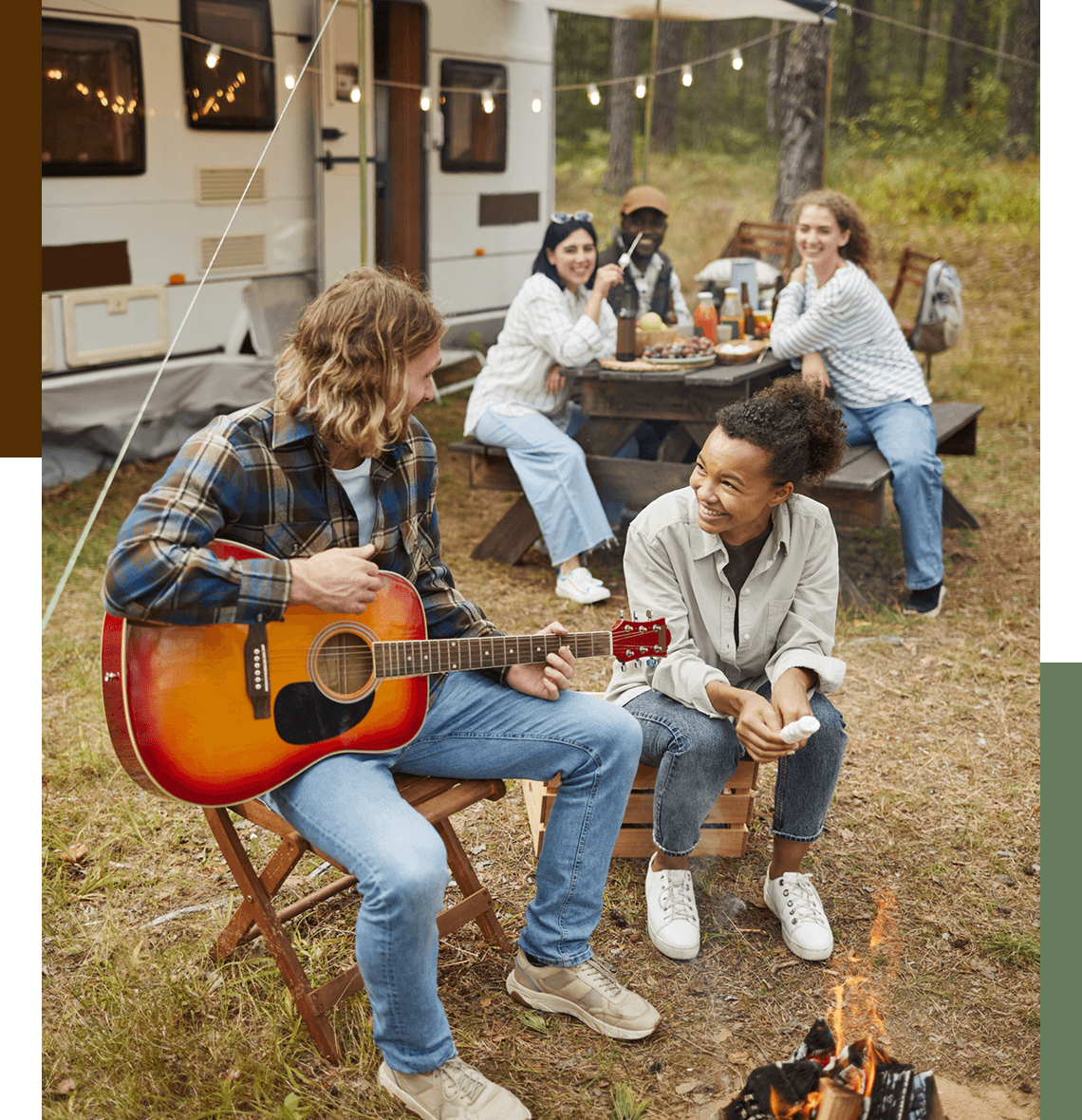 Friends enjoying music by a campfire