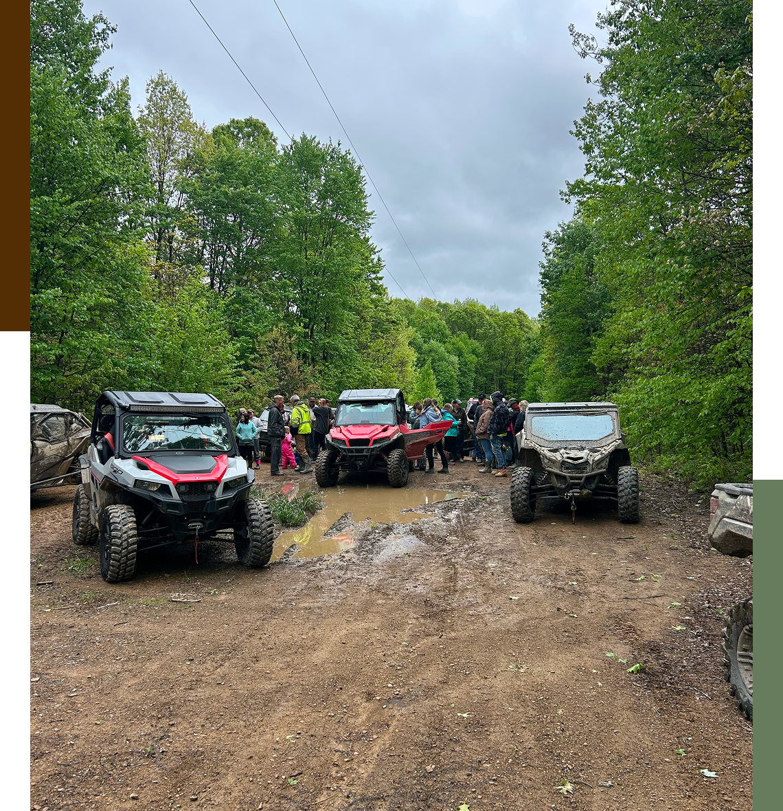 ATVs parked on a forest trail gathering.