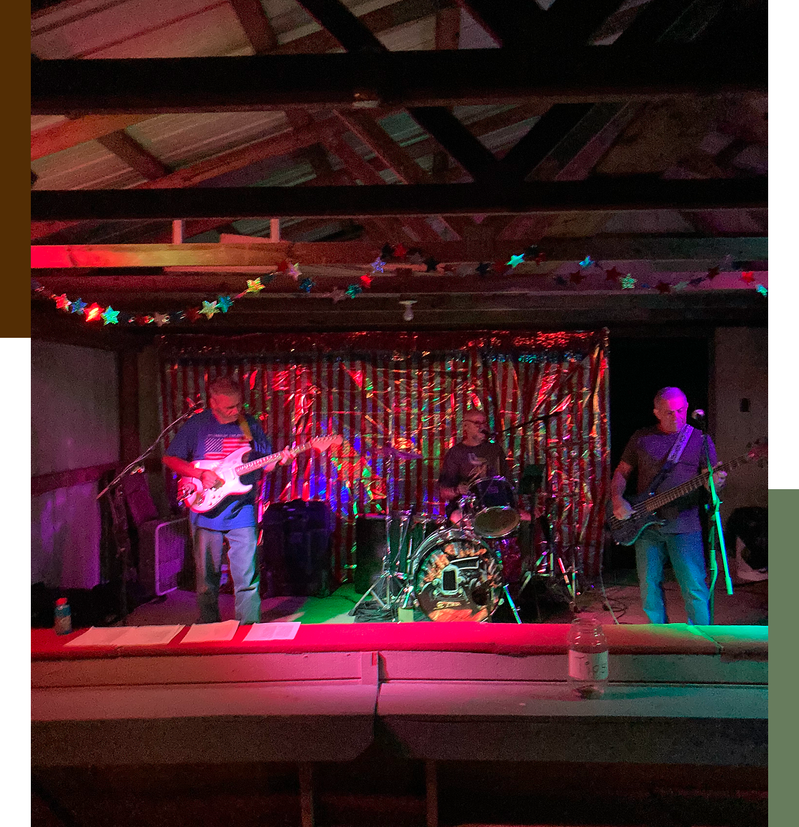 Band performing on stage with colorful lights.