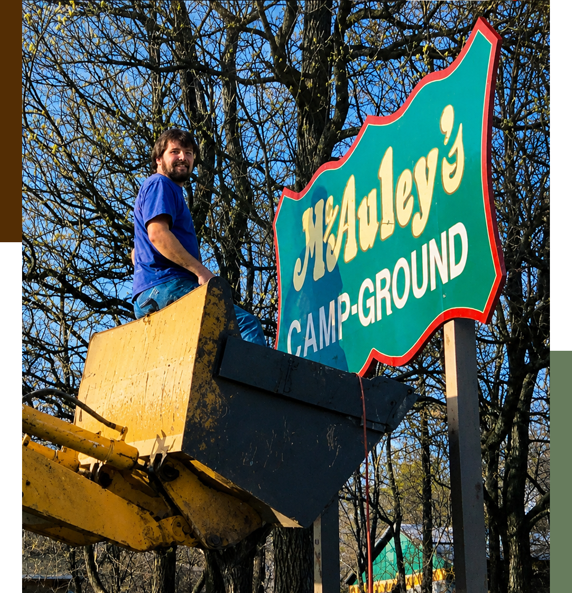 Man near McAuley's Campground sign.
