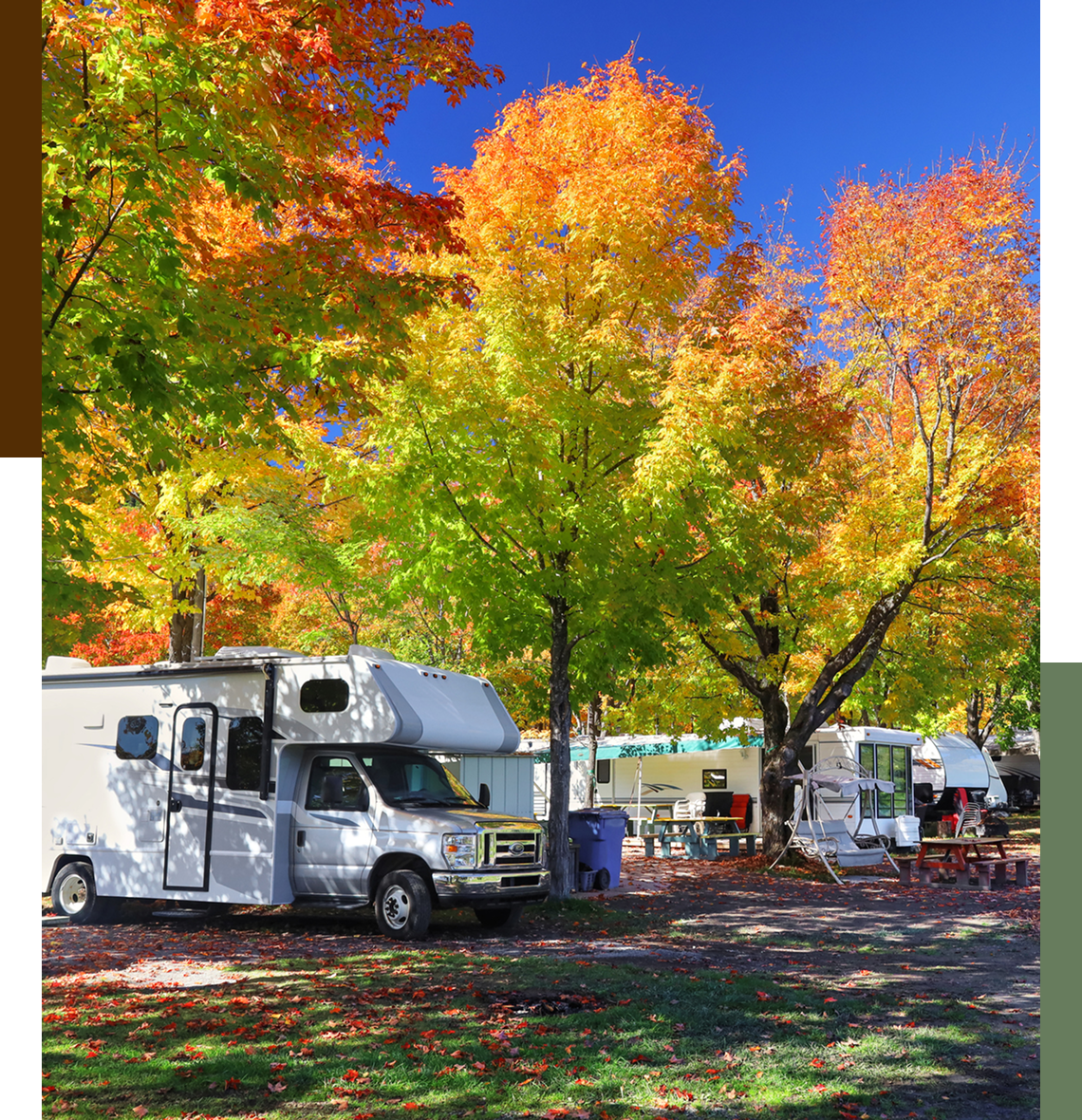 RVs parked under colorful autumn trees.